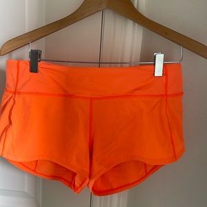 Bright orange Speed Up Lululemon 2.5” shorts